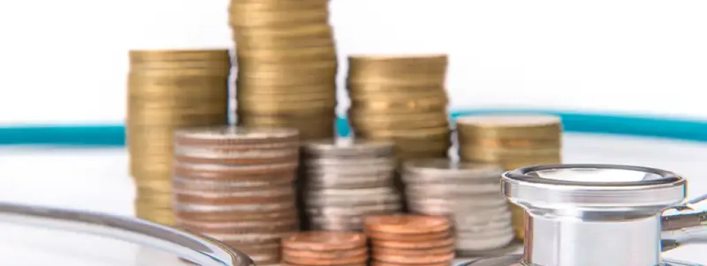 moedas-e-dinheiro-em-cima-de-mesa-com-aparelho-medico